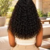 The Burmese Belle 22-inch Natural Black Burmese curls wig, rear view on a model.