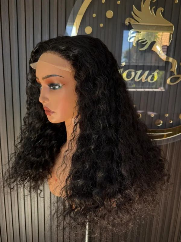 The Burmese Belle 22-inch Natural Black Burmese curls wig, side view on a mannequin.