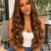 The Golden Belle 24-inch 4/27 bouncing curls wig, front view on a model.