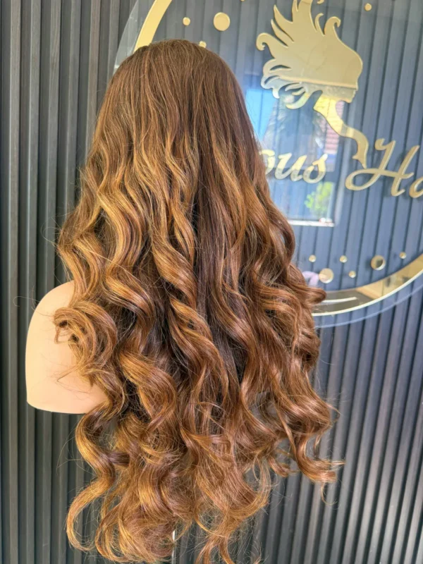 The Golden Belle 24-inch 4/27 bouncing curls wig, rear view on a mannequin.